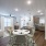 Bright and modern apartment interior showcasing an open-concept layout with a dining room, living room, and kitchen seamlessly connected.