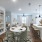 Alternate view of the apartment’s living spaces, highlighting the connected dining room, living room, and kitchen with abundant natural light and modern finishes.