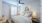 Secondary bedroom with soft natural light, neutral décor, and flexible space suitable for guests, a home office, or additional living needs