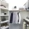 Secondary walk-in closet offering built-in shelves and generous hanging space, designed for organized and efficient storage.