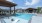 Oak at Katy Park pool with in-water lounge chairs and shaded seating