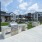 Outdoor corn hole area, pool, and grills
